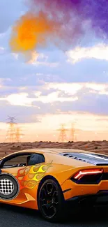 Orange sports car on desert road with vibrant sunset sky.