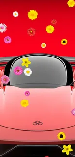 Red sports car with floating colorful flowers on a vibrant background.