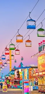 Vibrant carnival with colorful sky chairs and festive lights.