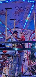 Father and child on carousel with blue lights.