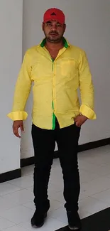 Person wearing a bright yellow shirt with casual black pants.