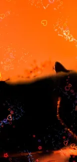 Cat silhouette on orange background with colorful heart patterns.