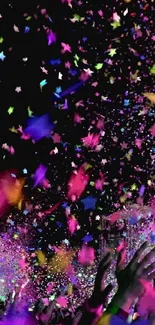Vibrant celebration with colorful confetti and lights on a dark background.