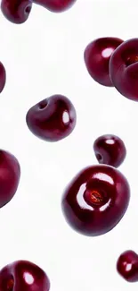 Glossy red cherries on a white mobile wallpaper background.