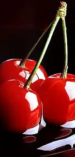 Vibrant red cherries on a glossy black surface.