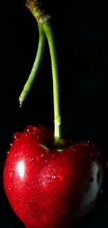 Vibrant red cherry on a sleek black background wallpaper.