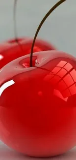 Glossy red cherries phone wallpaper with a vibrant, realistic finish.