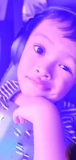 Child in headphones with purple hues, smiling playfully.