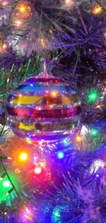 Colorful ornament hanging on a lit Christmas tree.