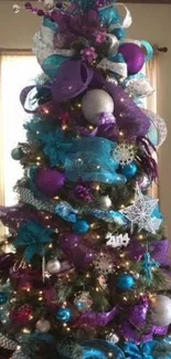 Purple and teal Christmas tree with ornaments.