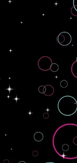 Mobile wallpaper with pink and cyan circles on a black background.