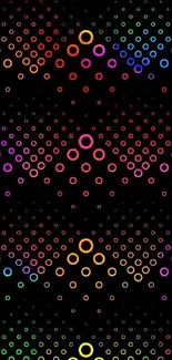 Vibrant multicolored circle pattern on black wallpaper.