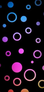 Colorful circles on black background wallpaper.