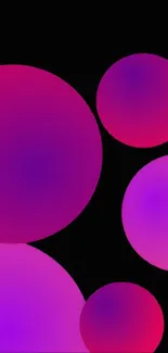 Vibrant pink and purple circles on black wallpaper.