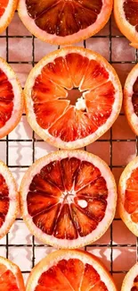 Sliced blood oranges on a grid, creating a vibrant, colorful pattern.