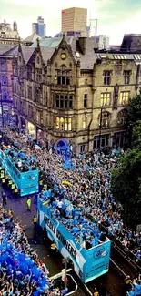 City parade with cheering crowd and team buses in vibrant celebration.