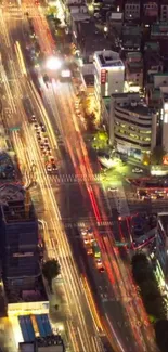 Bustling city street at night with colorful light trails.