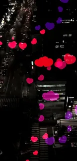 Aerial view of city street with floating red and purple hearts at night.