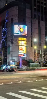 Nighttime cityscape with neon signs and busy streets.