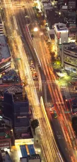 Aerial view of vibrant city street lights at night.