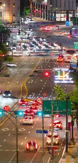 Vibrant downtown city street at night with bustling traffic and glowing lights.