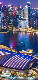 Nighttime Singapore skyline with Marina Bay Sands in vibrant blue hues.