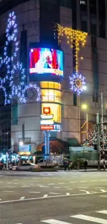 Nighttime city scene with bright lights and decorated buildings.