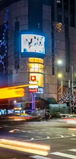 Dynamic cityscape at night with vibrant lights and motion.