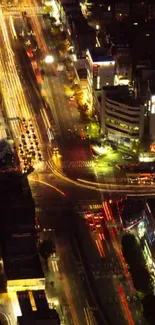 Aerial view of vibrant city lights at night revealing bustling urban traffic.