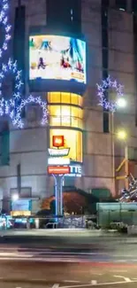 Vibrant city nightscape featuring illuminated buildings and street lights.