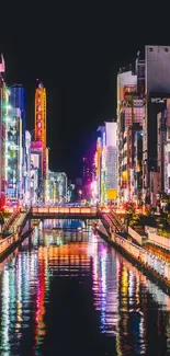 Vibrant cityscape at night with neon-lit buildings reflecting on a canal.