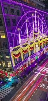 Festive building lights up a city street at night, vibrant holiday scene.