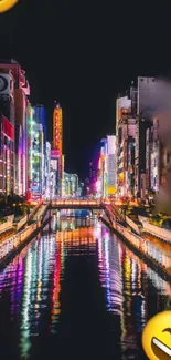 Vibrant city at night with colorful reflections on a river.