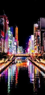 Vibrant city nightscape with neon reflections on a water canal.