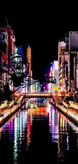 Vibrant city nightscape with colorful lights reflecting on a canal.