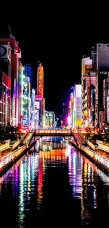 Bright neon-lit cityscape reflecting on water at night.