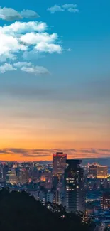 City skyline at sunset with glowing tower and vibrant sky.