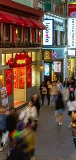 Crowded night city street with colorful lights and vibrant activity.