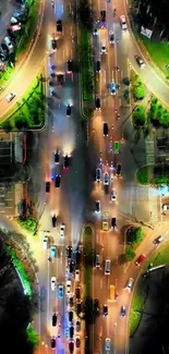 Aerial view of vibrant city intersection at night with colorful traffic lights.