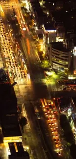 Aerial view of a city street lively with night lights.