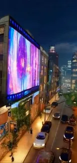 Vibrant city street at night with colorful billboards.