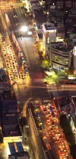 Aerial view of a vibrant cityscape with colorful night lights and dynamic traffic.