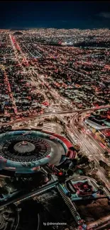 Stunning aerial view of a vibrant city at night with illuminated streets and buildings.