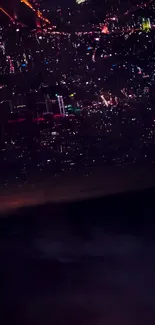 City skyline at night with vibrant lights glowing against a dark sky.