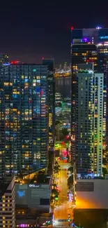 Night view of vibrant cityscape with illuminated skyscrapers.