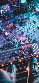 Aerial view of a vibrant city street with lights and bustling nightlife.