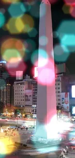 Cityscape at night with bright urban lights and a tall landmark monument.