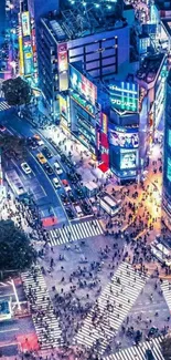 A vibrant cityscape at night with neon lights and crowded crosswalks.