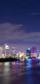 Vibrant city skyline reflecting at night.