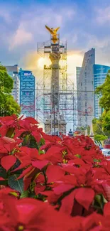 Cityscape with red flowers and monument under blue sky.